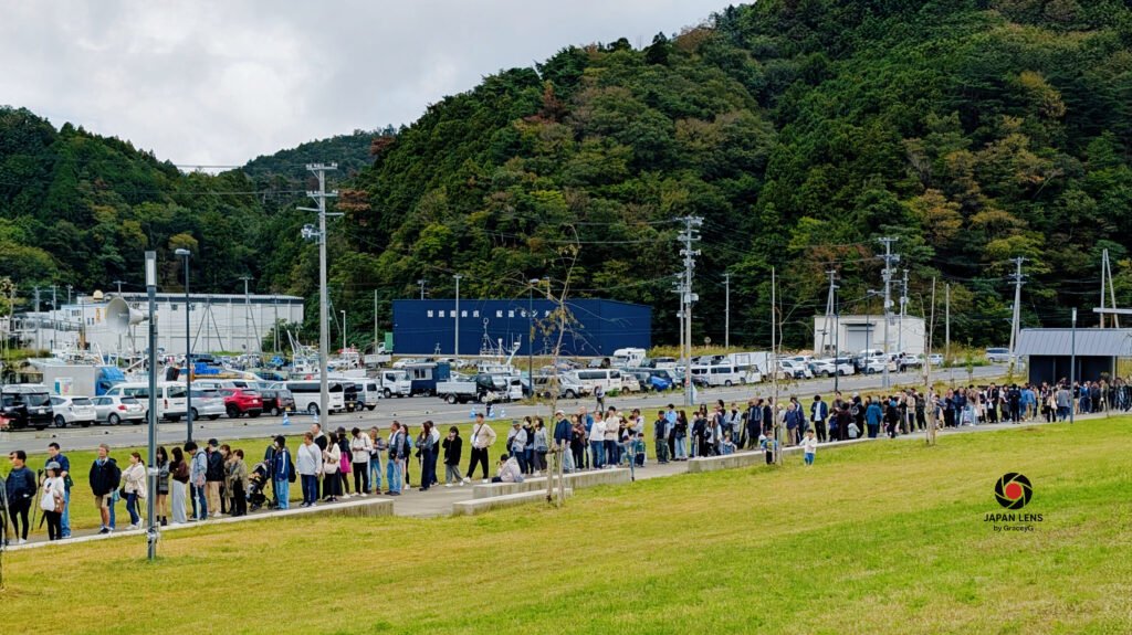 Long line of visitors waiting for grilled sanma at Onagawa Harvest Festival 2025, Miyagi Prefecture, Japan — photo by Japan Lens by GraceyG.